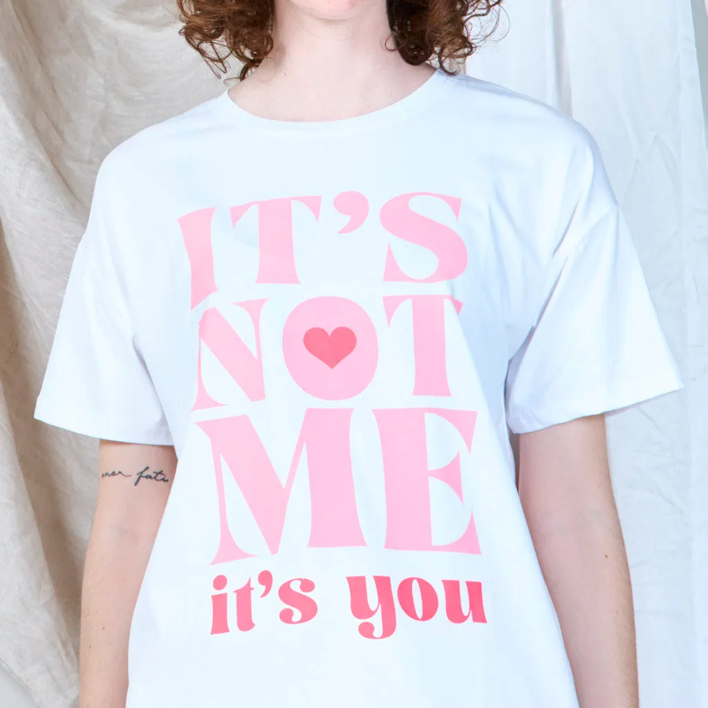 Bold statement graphic "IT'S NOT ME" t-shirt wholesale